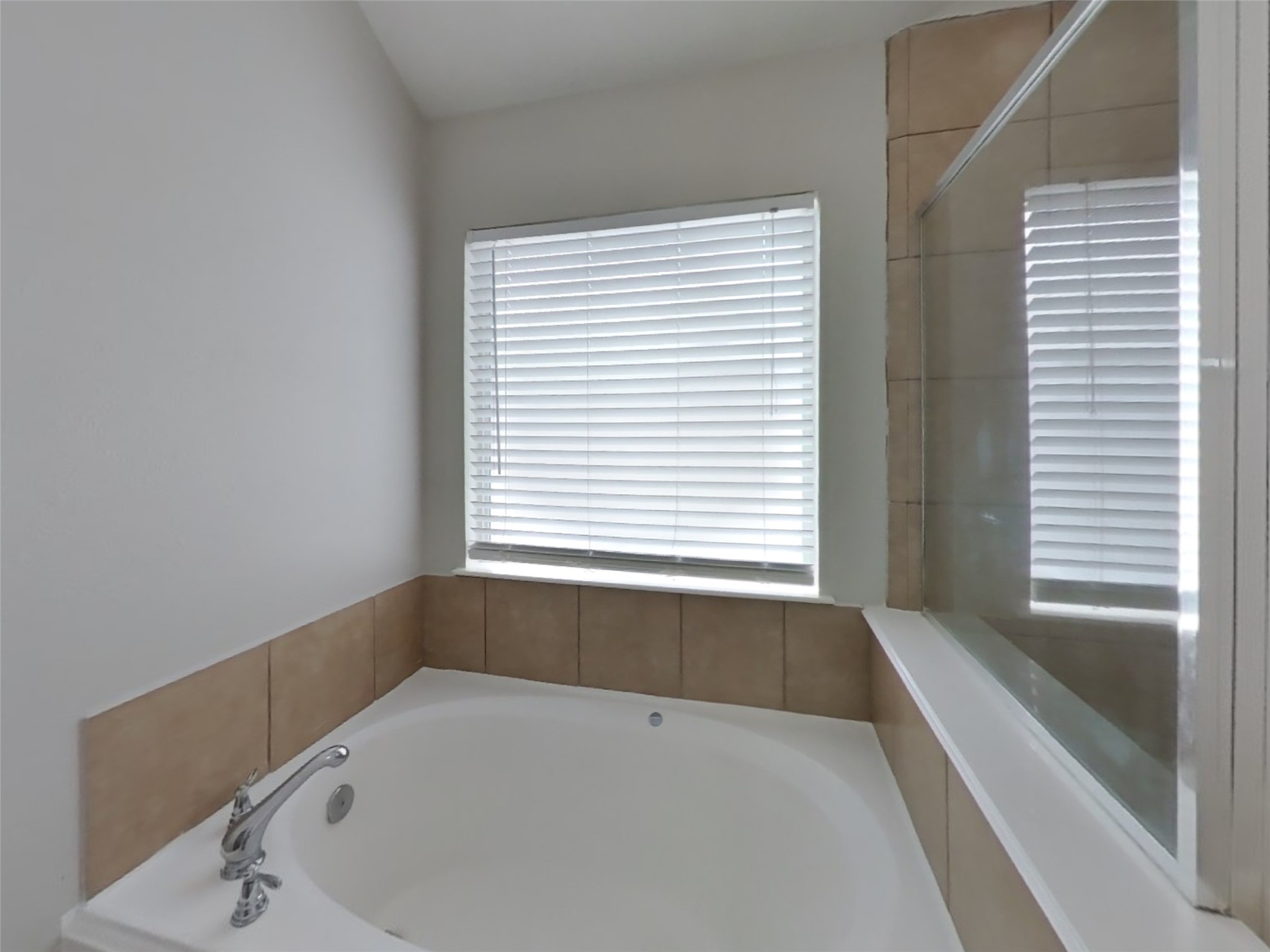 21526 Lovis Way Humble, TX 77338 - Photo 9 of 17 a bathroom with a bathtub and a window