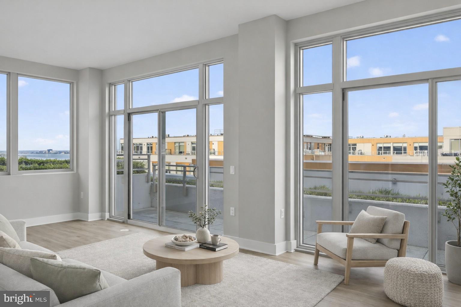 a living room with furniture and a floor to ceiling window