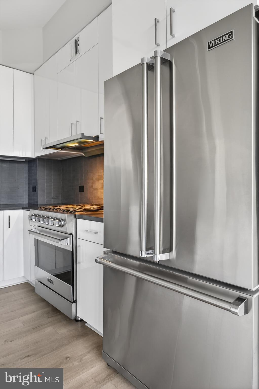 88 V Street Southwest, Unit PH3 Washington, DC 20024 - Photo 11 of 49 a kitchen with white cabinets and stainless steel appliances