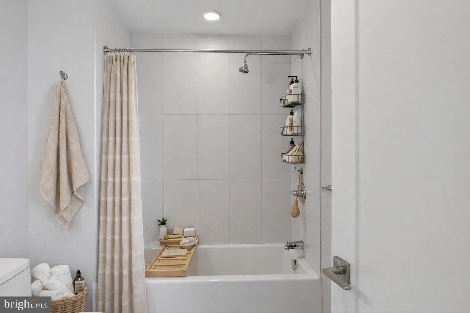 88 V Street Southwest, Unit PH3 Washington, DC 20024 - Photo 21 of 49 a bathroom with a bathtub and shower