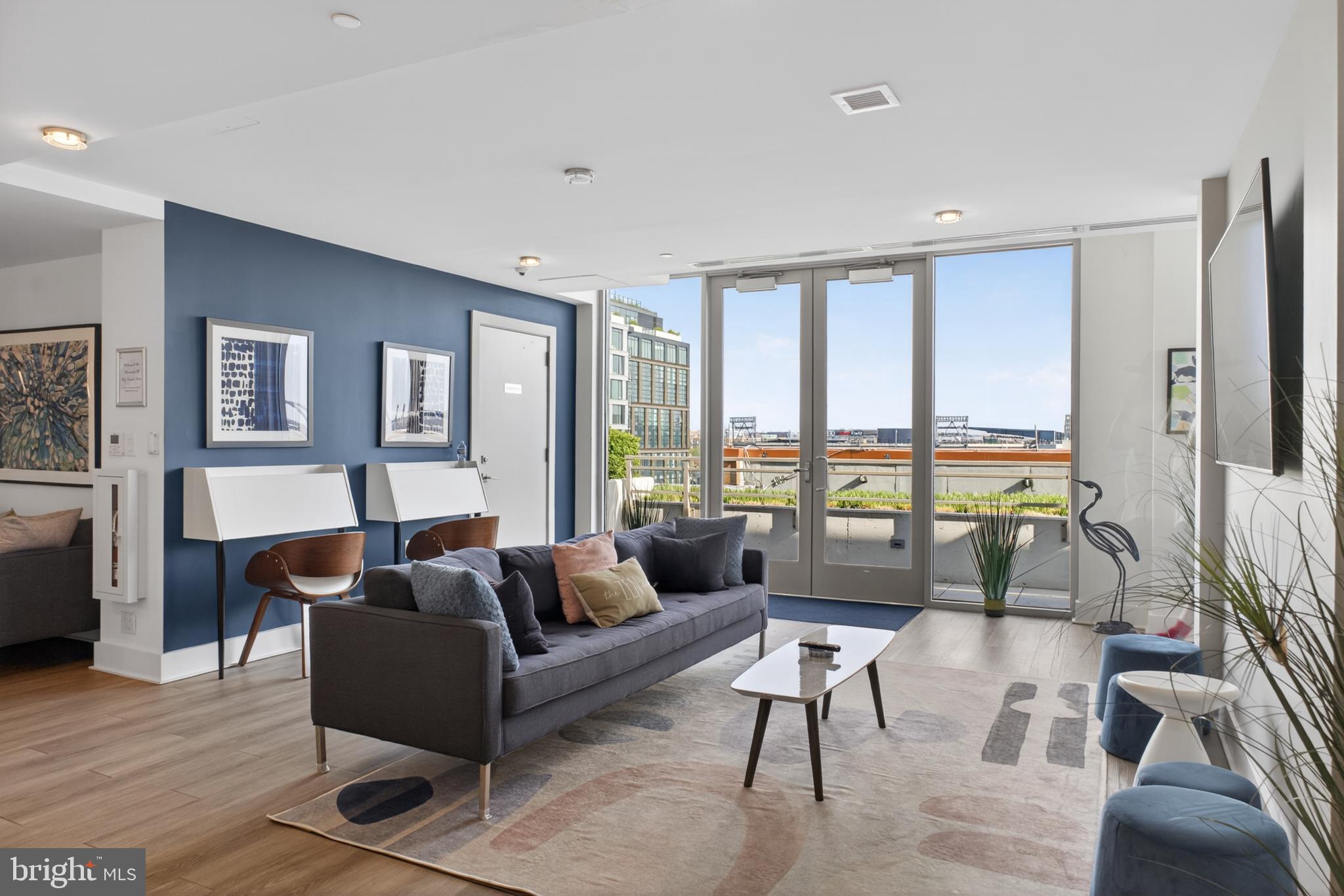 88 V Street Southwest, Unit PH3 Washington, DC 20024 - Photo 39 of 49 a living room with furniture and floor to ceiling windows