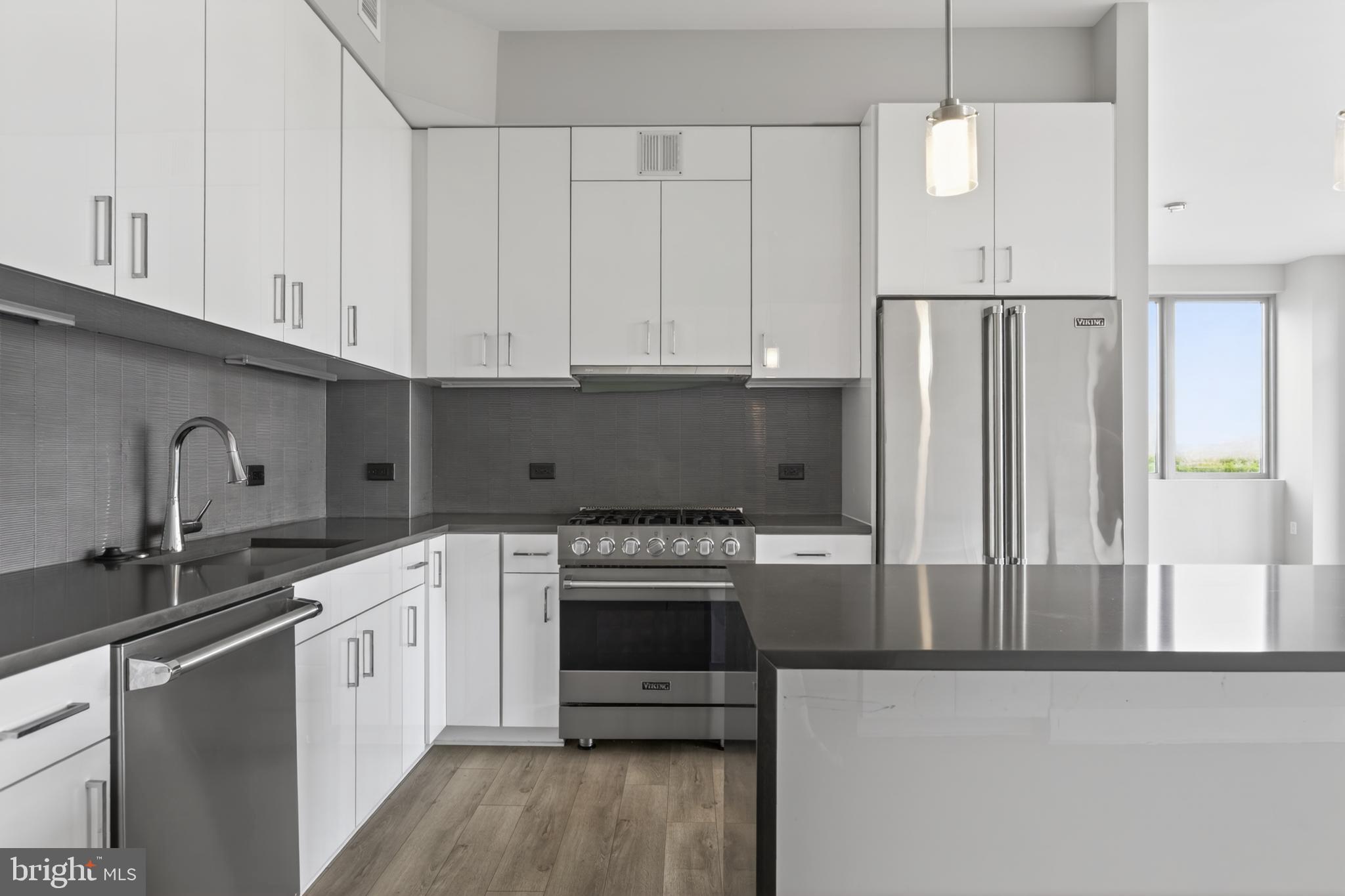88 V Street Southwest, Unit PH3 Washington, DC 20024 - Photo 9 of 49 a kitchen with stainless steel appliances granite countertop a stove a refrigerator and a sink
