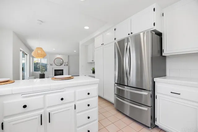 a kitchen with cabinets and stainless steel appliances