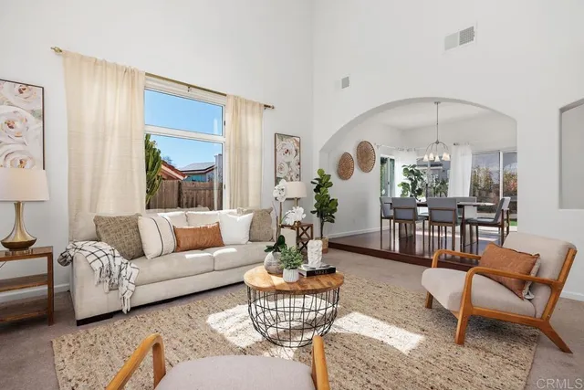 a living room with furniture and a chandelier