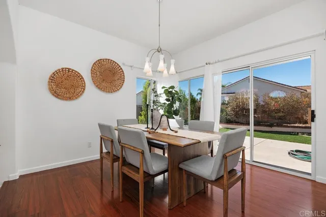 a view of a dining room with furniture wooden floor and chandelier