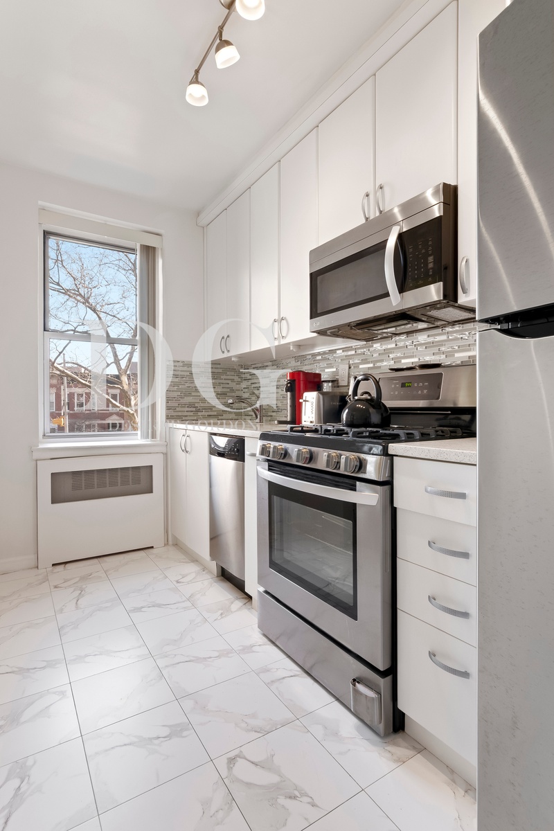 36 Dahill Road, Unit 2I Brooklyn, NY 11218 - Photo 6 of 9 a kitchen with stainless steel appliances a stove sink and microwave