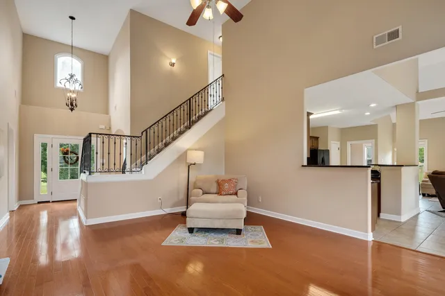 a living room with furniture and a chandelier