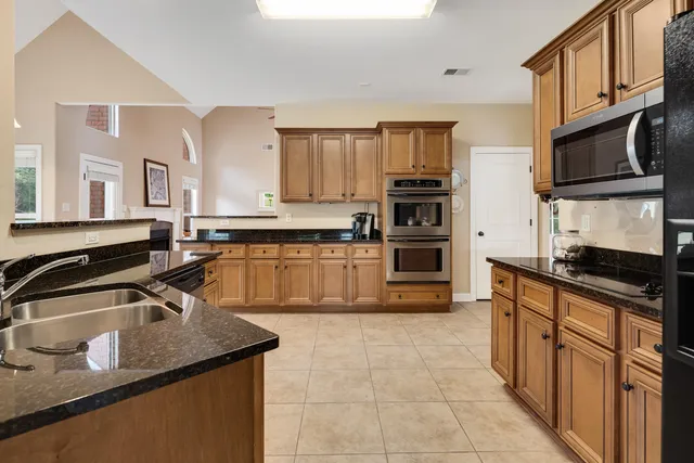 a kitchen with a sink stove and cabinets