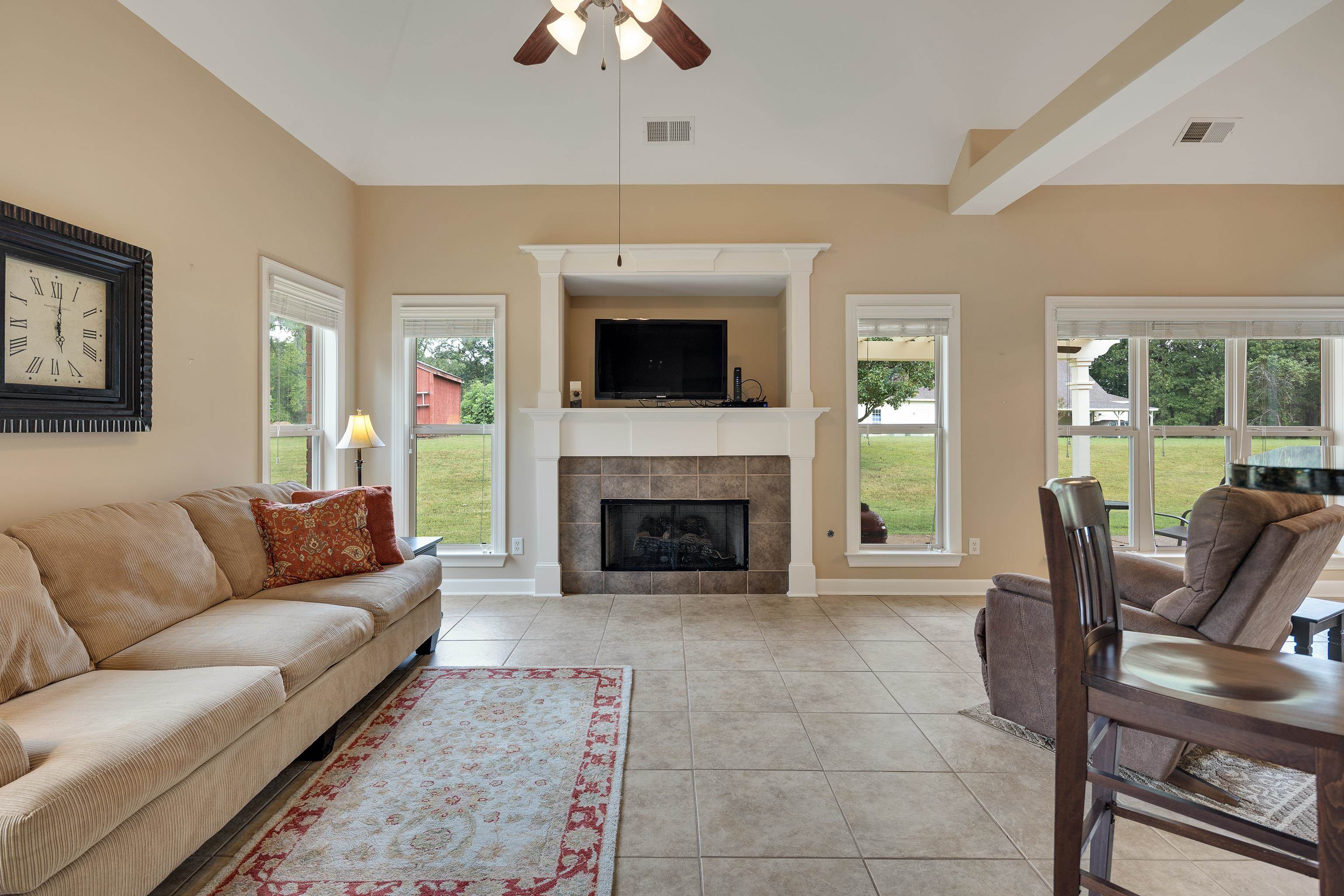 90 Rolling Meadows Road Somerville, TN 38068 - Photo 16 of 37 a living room with furniture a flat screen tv and a fireplace