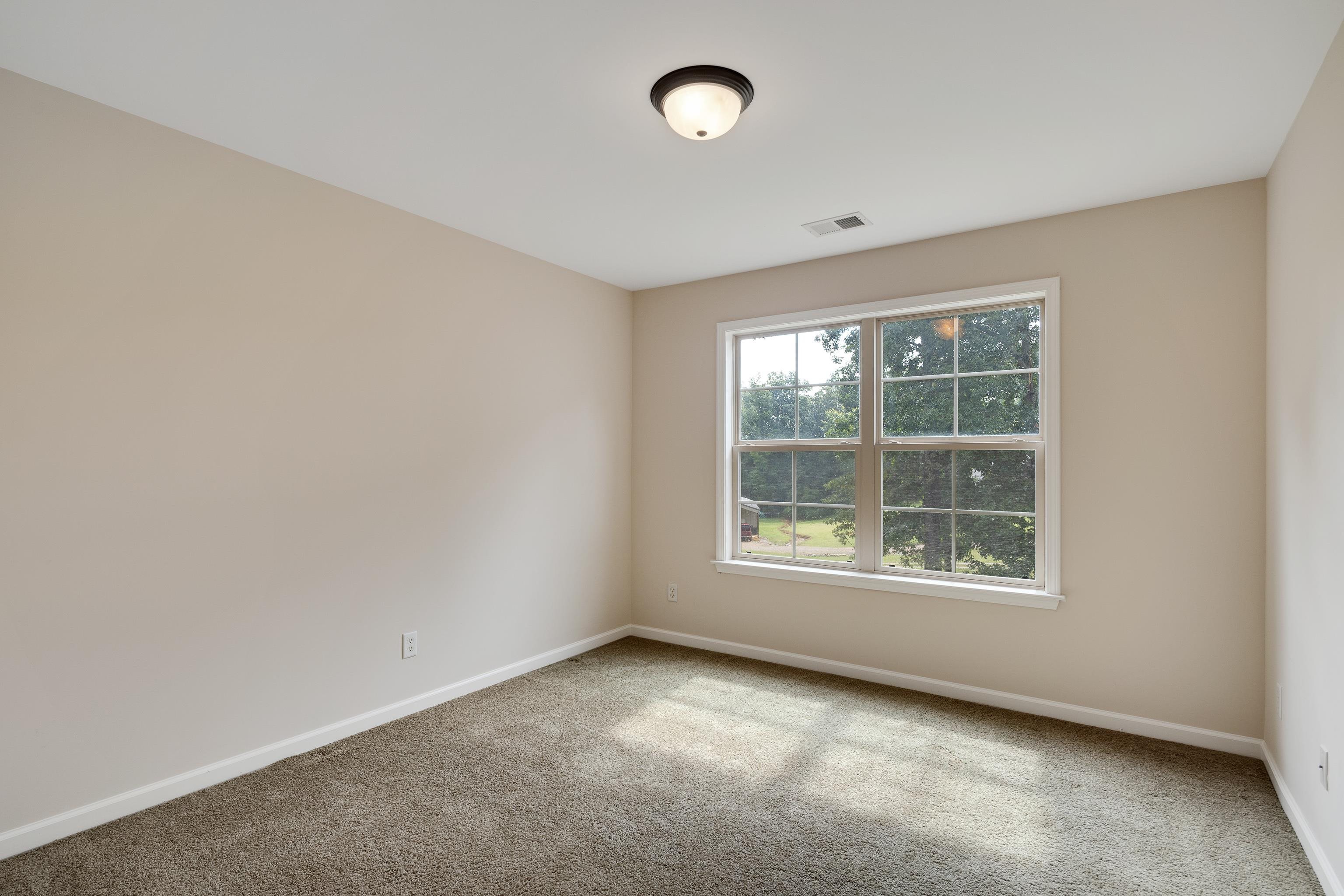 90 Rolling Meadows Road Somerville, TN 38068 - Photo 23 of 37 an empty room with a window