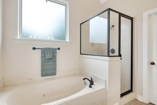 a bathroom with a bathtub and a shower