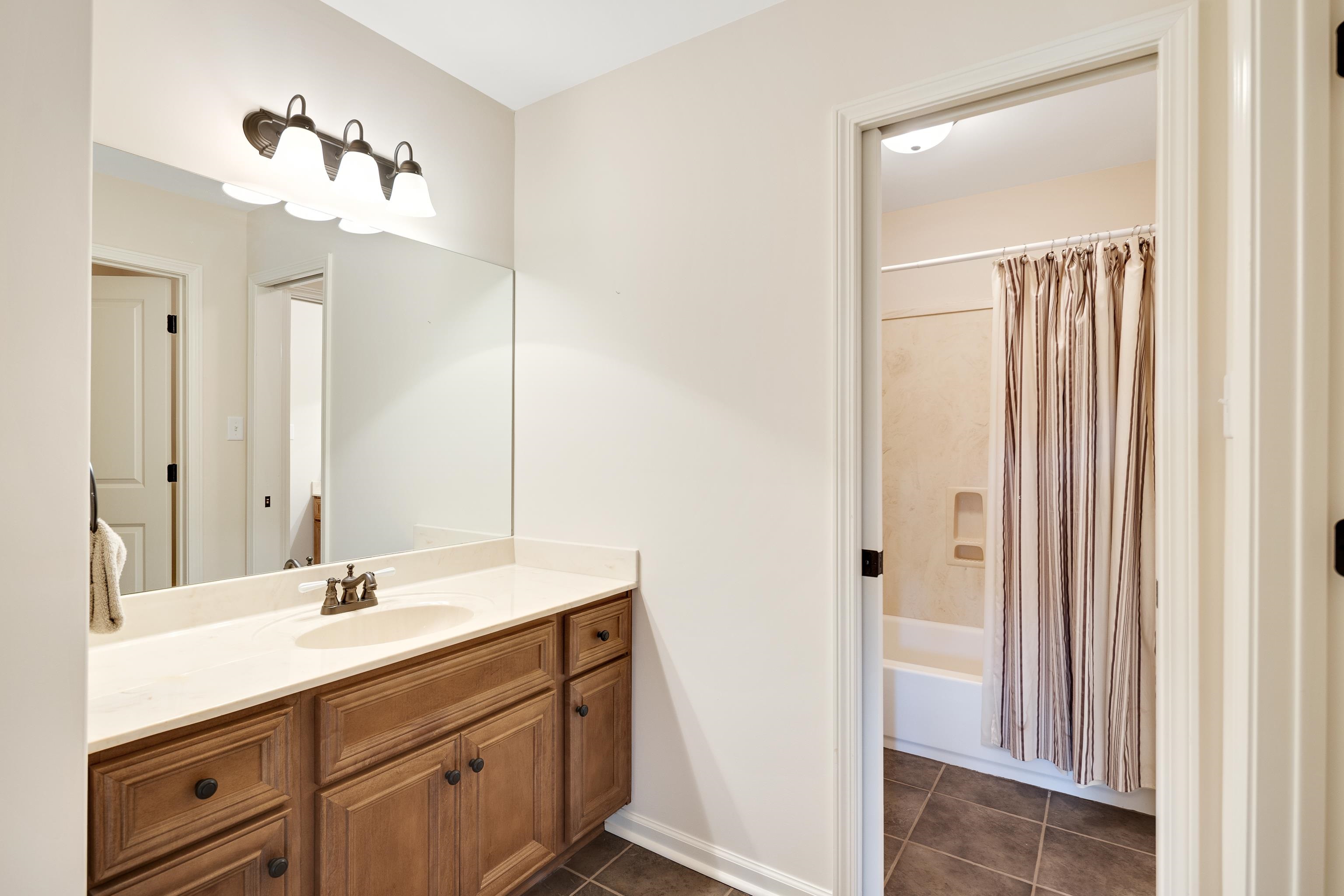 90 Rolling Meadows Road Somerville, TN 38068 - Photo 25 of 37 a bathroom with a double vanity sink and a mirror