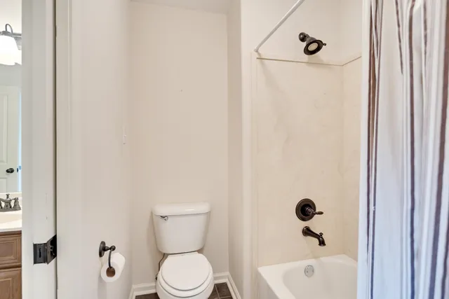 a bathroom with a toilet and a tub