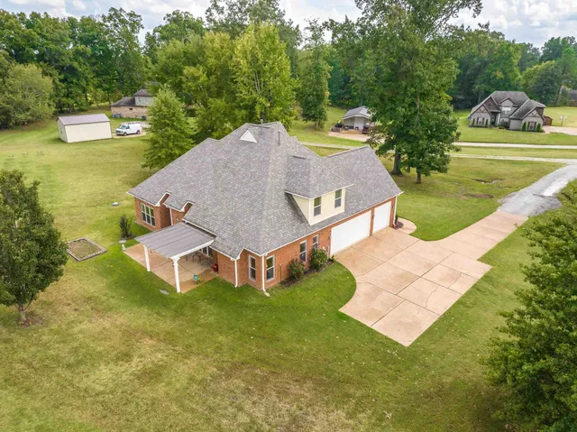 an aerial view of a house with swimming pool and big yard
