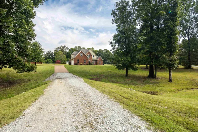 a front view of house with yard and green space