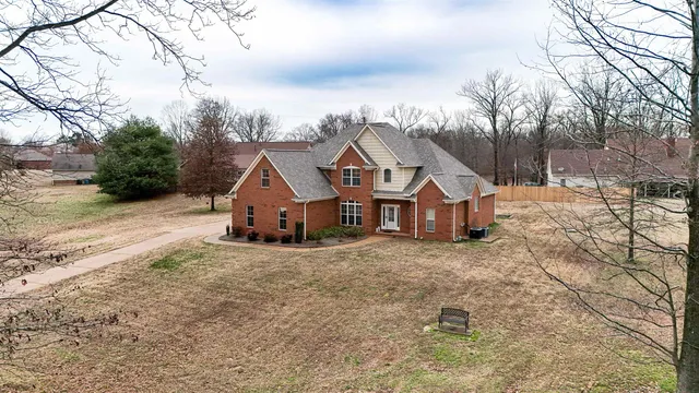 a view of a house with a yard covered in snow