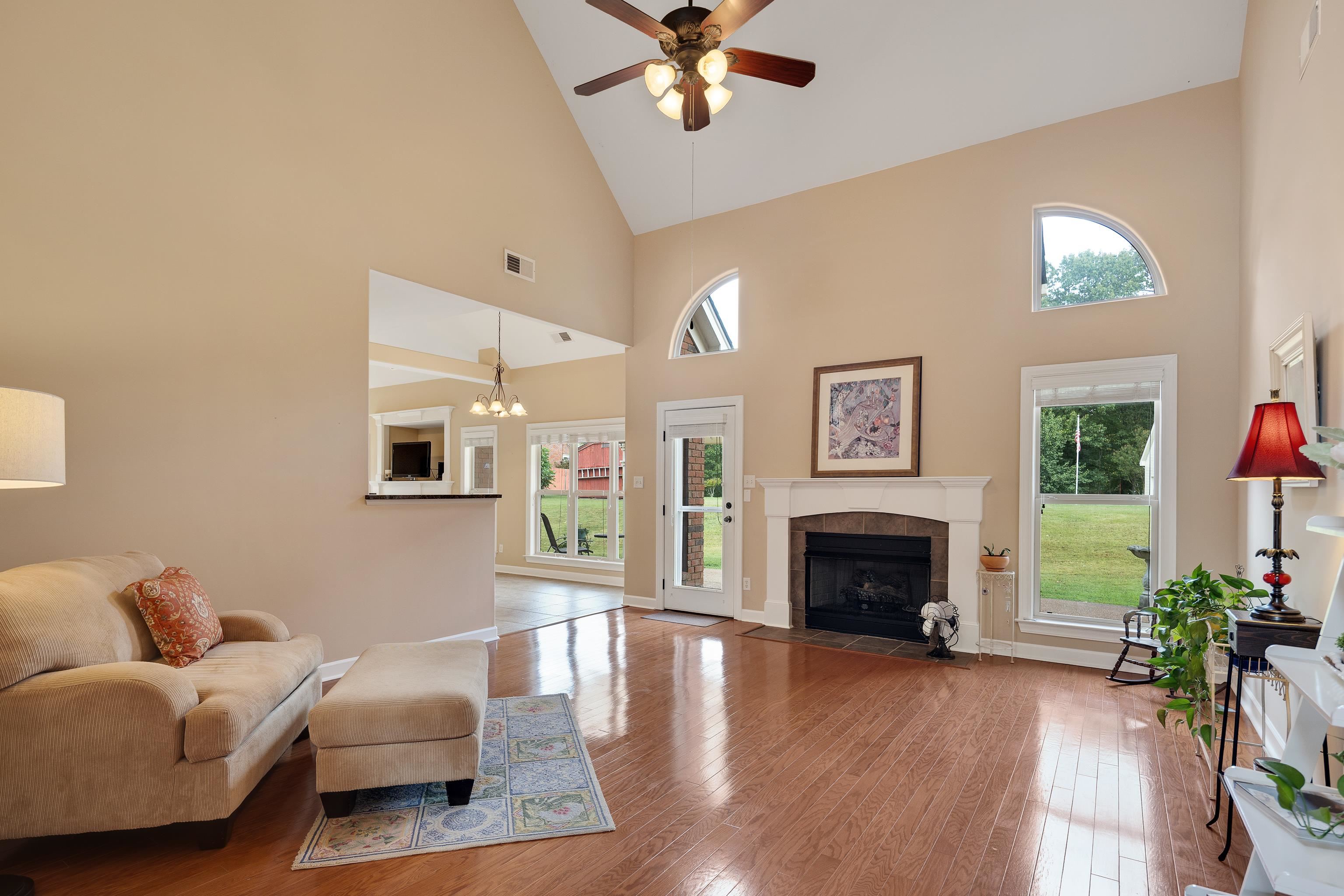 90 Rolling Meadows Road Somerville, TN 38068 - Photo 9 of 37 a living room with furniture a fireplace and a floor to ceiling window