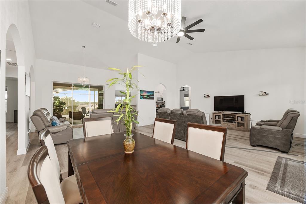 4321 Southwest 106th Place Ocala, FL 34476 - Photo 17 of 82 a living room with furniture a chandelier and a flat screen tv