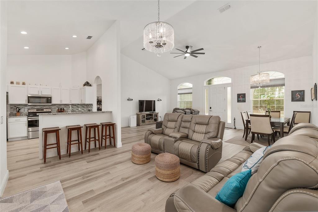 4321 Southwest 106th Place Ocala, FL 34476 - Photo 20 of 82 a living room with furniture kitchen view and a chandelier