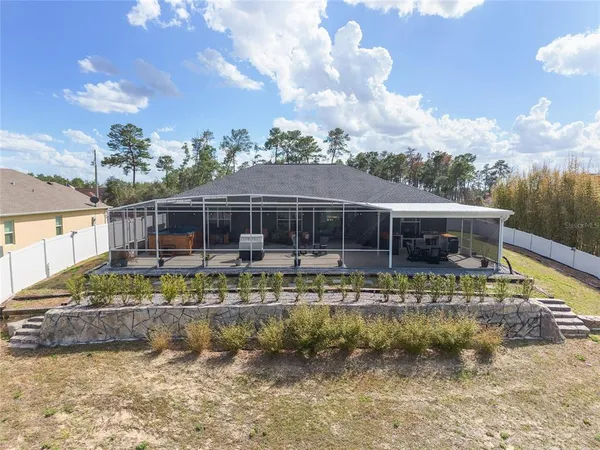 a view of house with swimming pool and lake view
