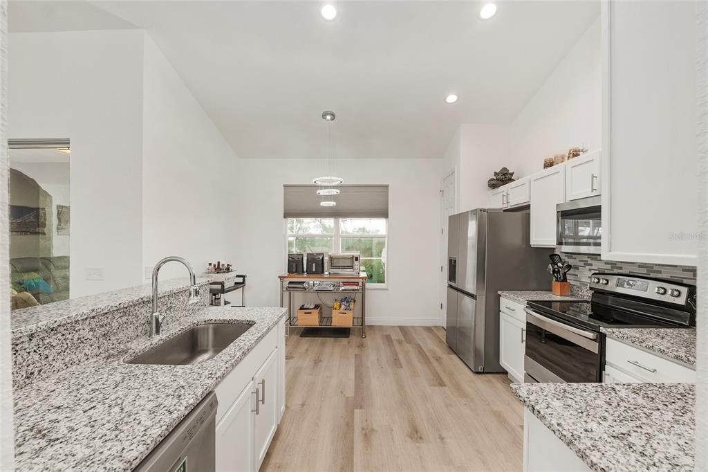 4321 Southwest 106th Place Ocala, FL 34476 - Photo 25 of 82 a kitchen with granite countertop a sink a counter space appliances and cabinets
