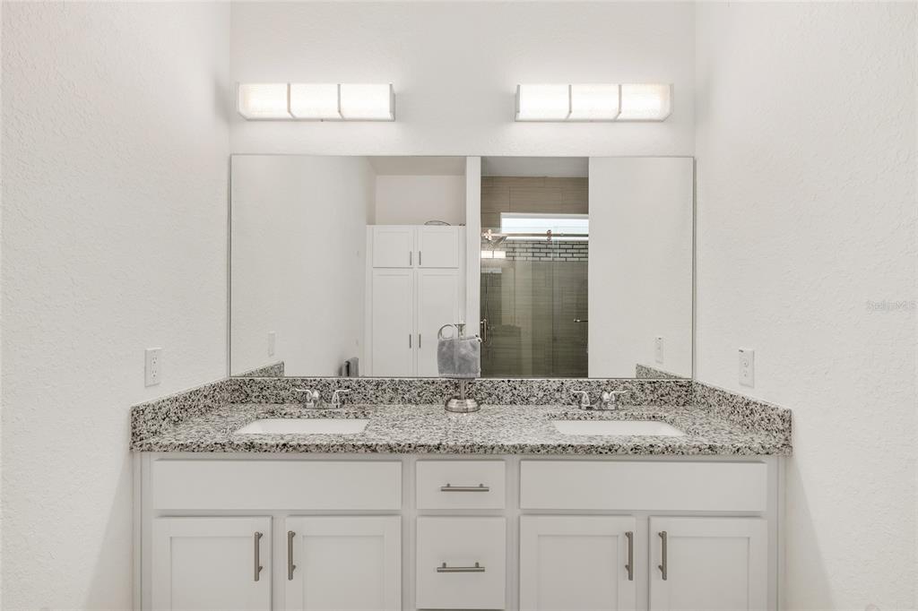 4321 Southwest 106th Place Ocala, FL 34476 - Photo 35 of 82 a bathroom with a granite countertop sink and a mirror