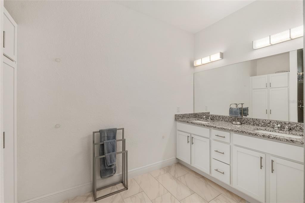 4321 Southwest 106th Place Ocala, FL 34476 - Photo 38 of 82 a bathroom with a granite countertop sink and a mirror