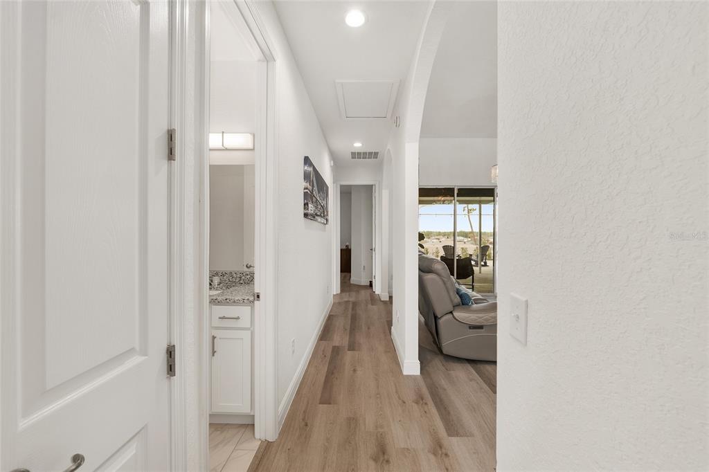 4321 Southwest 106th Place Ocala, FL 34476 - Photo 41 of 82 a view of a hallway with wooden floor and furniture