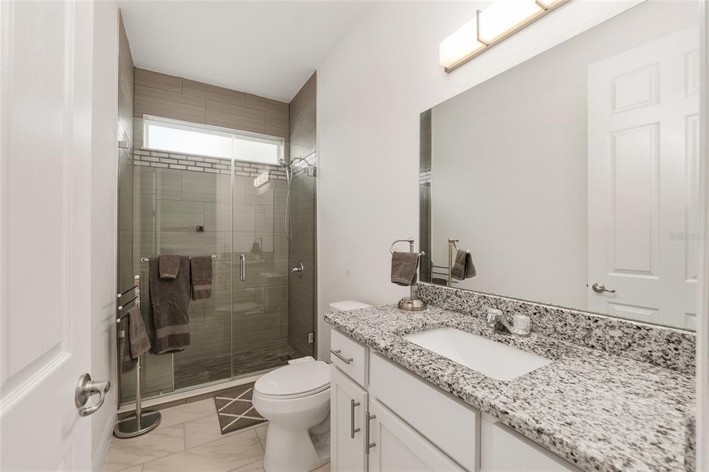 4321 Southwest 106th Place Ocala, FL 34476 - Photo 42 of 82 a bathroom with a granite countertop sink toilet and shower