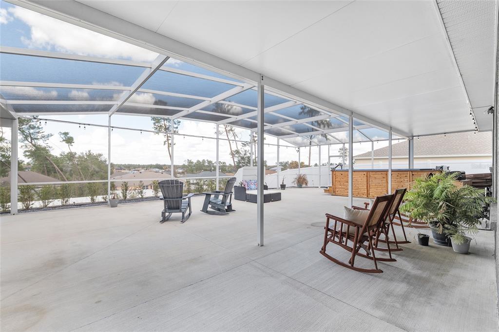 4321 Southwest 106th Place Ocala, FL 34476 - Photo 52 of 82 a view of a patio with a table and chairs and potted plants