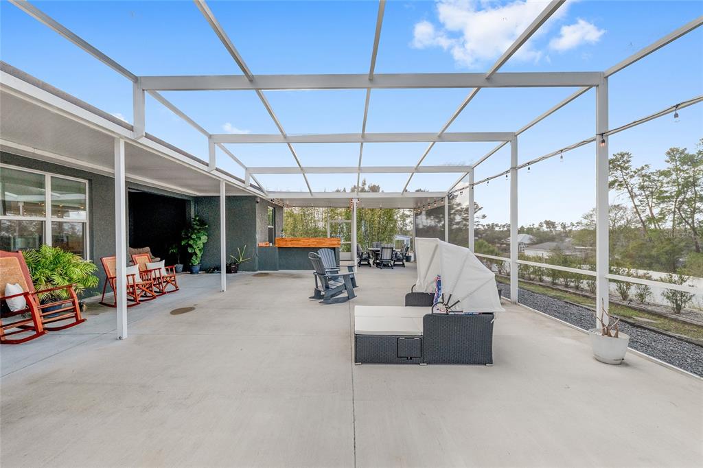 4321 Southwest 106th Place Ocala, FL 34476 - Photo 59 of 82 a view of a patio with table and chairs