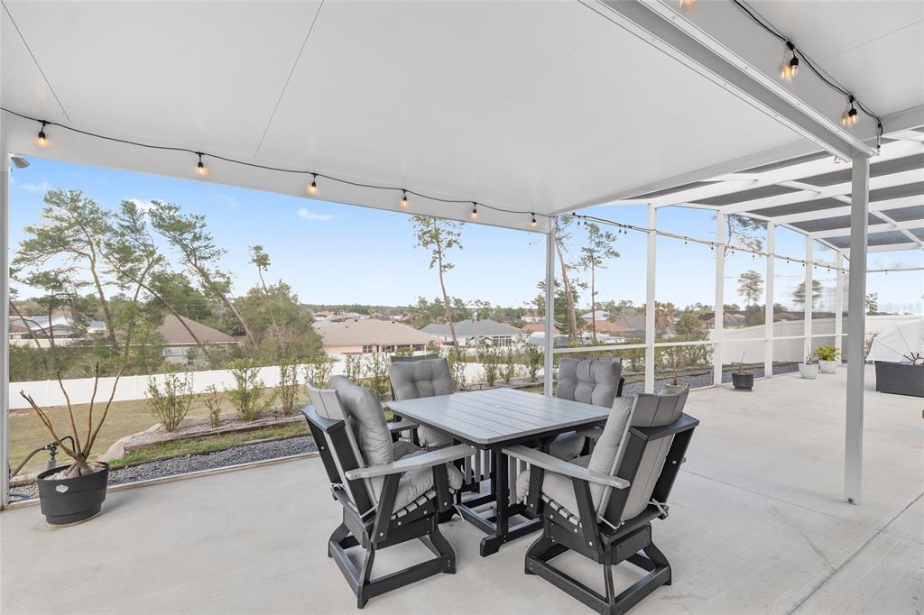 4321 Southwest 106th Place Ocala, FL 34476 - Photo 65 of 82 a dining room with furniture and a floor to ceiling window