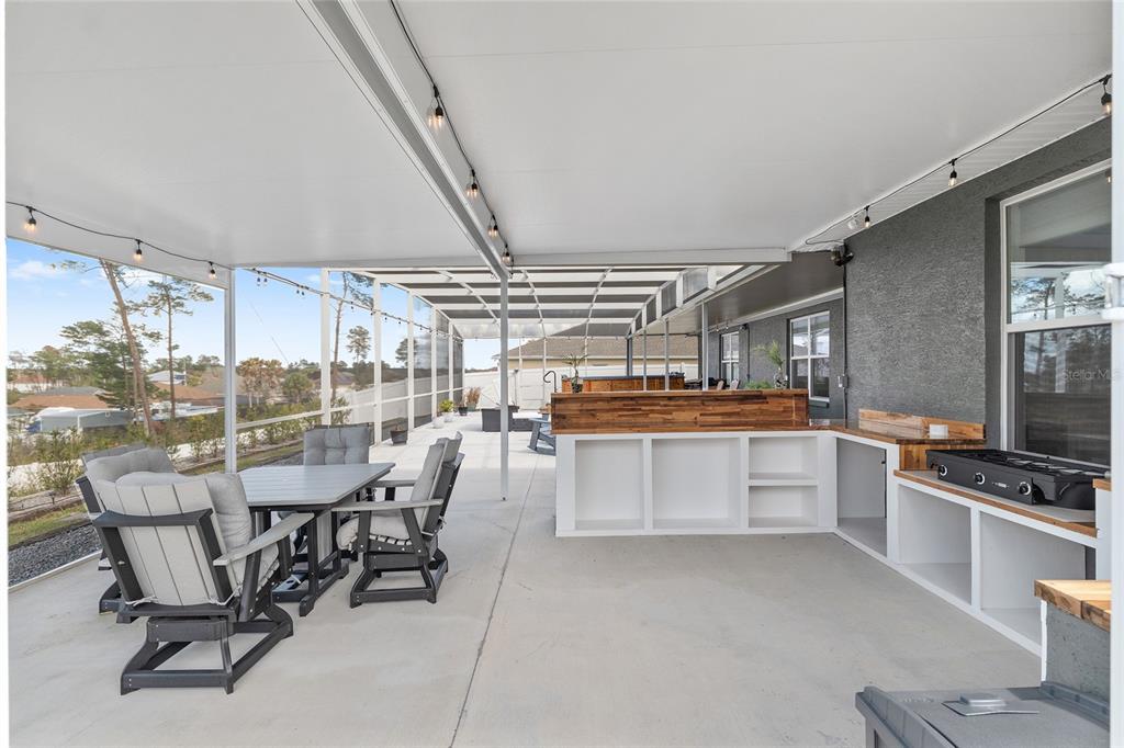 4321 Southwest 106th Place Ocala, FL 34476 - Photo 68 of 82 a dining area with furniture and a kitchen view