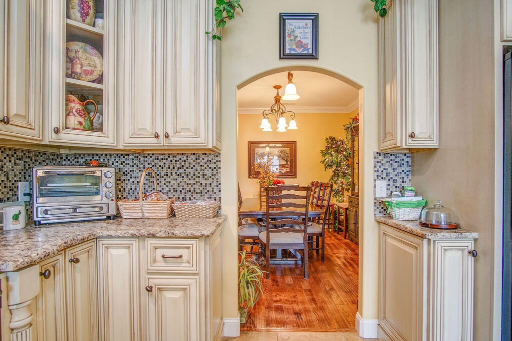 734 Bryant Road Cohutta, GA 30710 - Photo 21 of 42 an outdoor kitchen with granite countertop a stove a sink and a dining table with garden view