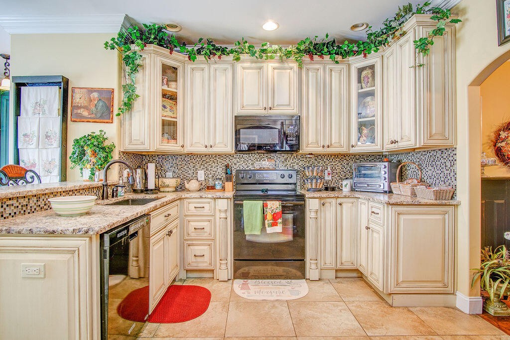 734 Bryant Road Cohutta, GA 30710 - Photo 22 of 42 a kitchen with stainless steel appliances granite countertop a stove a sink and cabinets