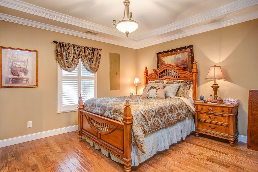 734 Bryant Road Cohutta, GA 30710 - Photo 27 of 42 a bedroom with a bed next to a window and a chandelier