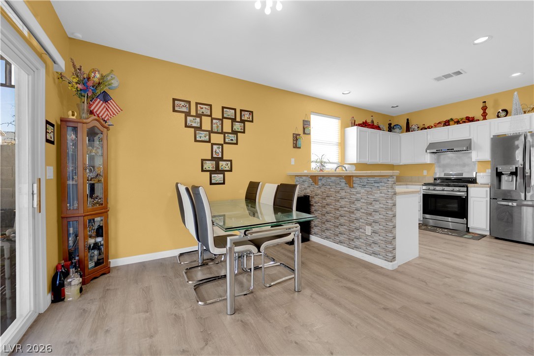 8170 West Festuca Way Las Vegas, NV 89113 - Photo 11 of 29 Dining room with light wood finished floors and recessed lighting