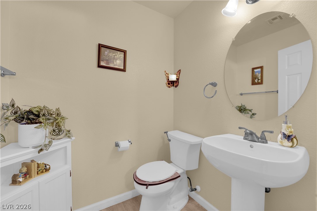 8170 West Festuca Way Las Vegas, NV 89113 - Photo 17 of 29 Half bathroom featuring toilet and baseboards
