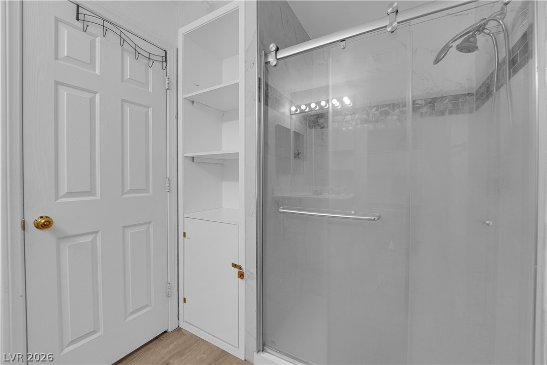 8170 West Festuca Way Las Vegas, NV 89113 - Photo 21 of 29 Full bath with a stall shower and light wood finished floors