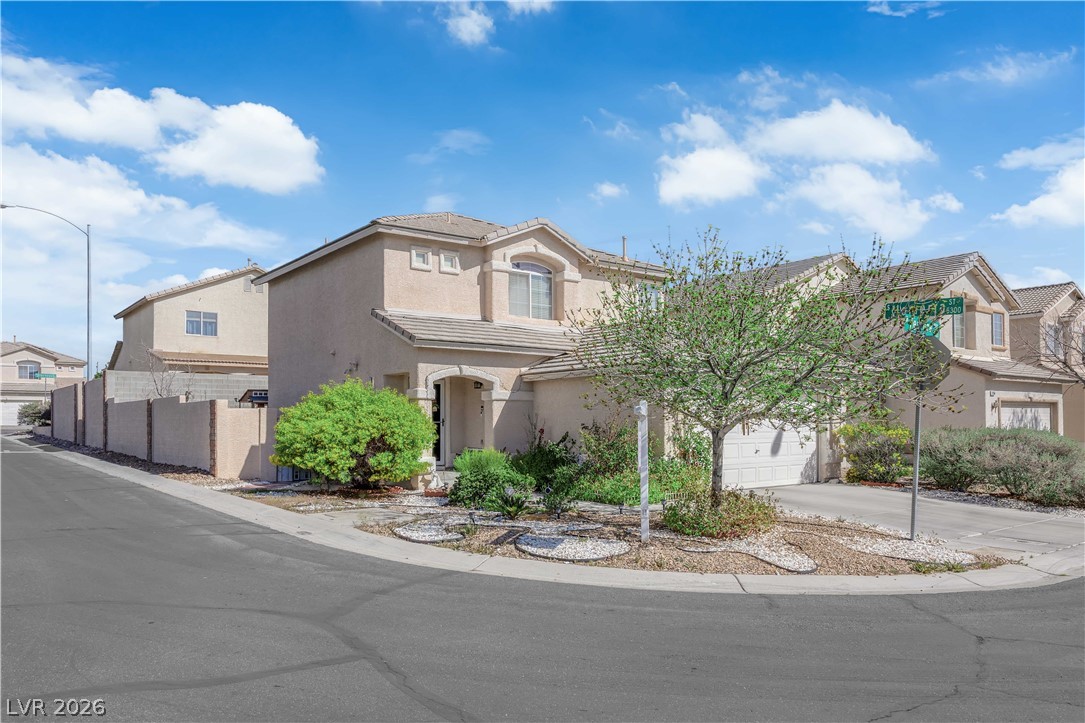 8170 West Festuca Way Las Vegas, NV 89113 - Photo 25 of 29 View of front of house with stucco siding, concrete driveway, a tile roof, and a residential view