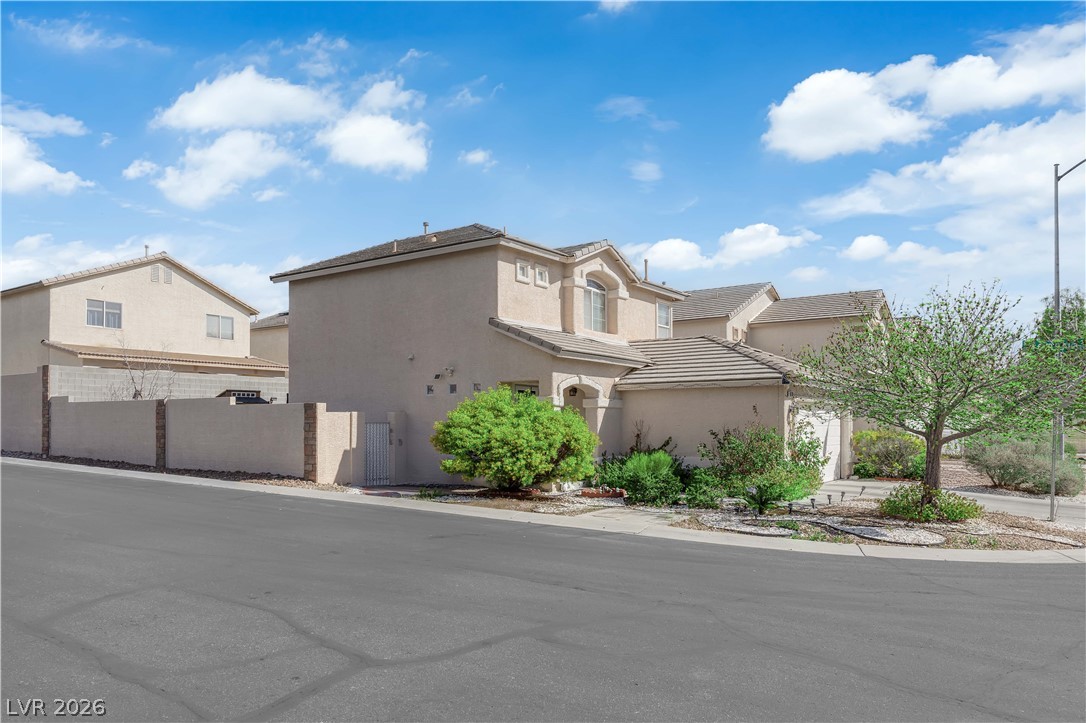 8170 West Festuca Way Las Vegas, NV 89113 - Photo 26 of 29 View of front of property featuring stucco siding and a gate