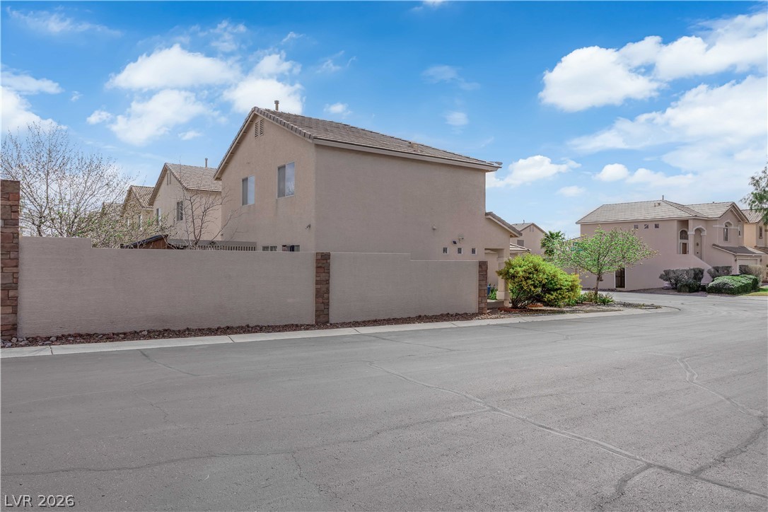 8170 West Festuca Way Las Vegas, NV 89113 - Photo 27 of 29 View of property exterior featuring a residential view and stucco siding