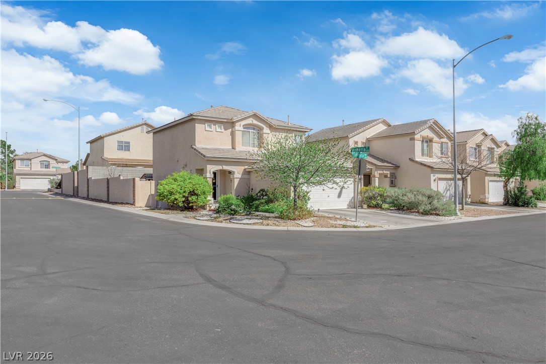 8170 West Festuca Way Las Vegas, NV 89113 - Photo 29 of 29 View of front of house featuring a residential view, stucco siding, a garage, and a gate