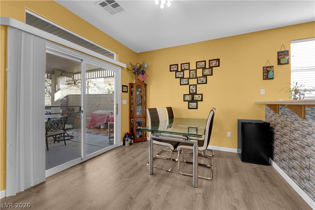 8170 West Festuca Way Las Vegas, NV 89113 - Photo 10 of 29 Dining space featuring wood finished floors and baseboards