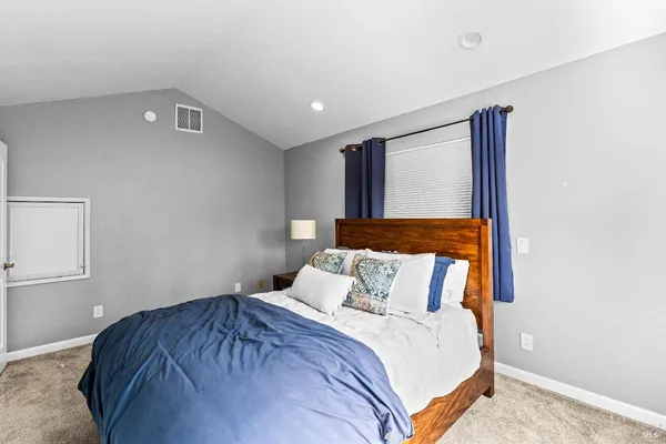 a bedroom with a bed and a window