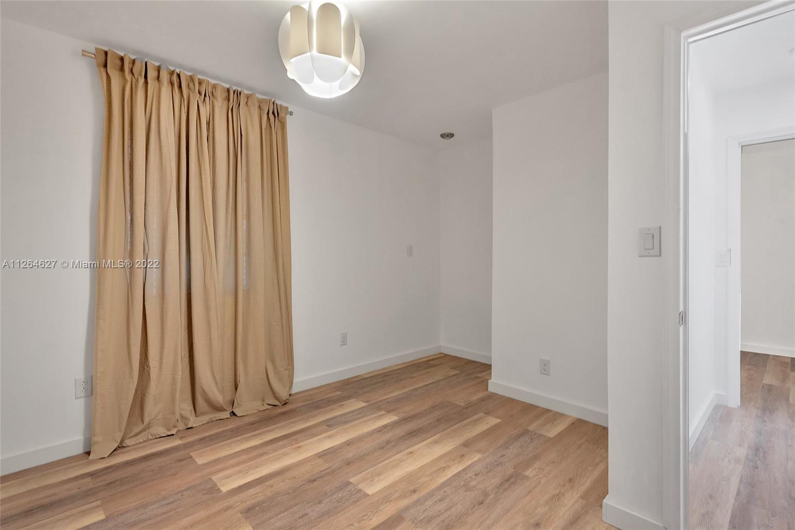 633 West 3rd Street Riviera Beach, FL 33404 - Photo 23 of 52 a view of a room with wooden floor and a window