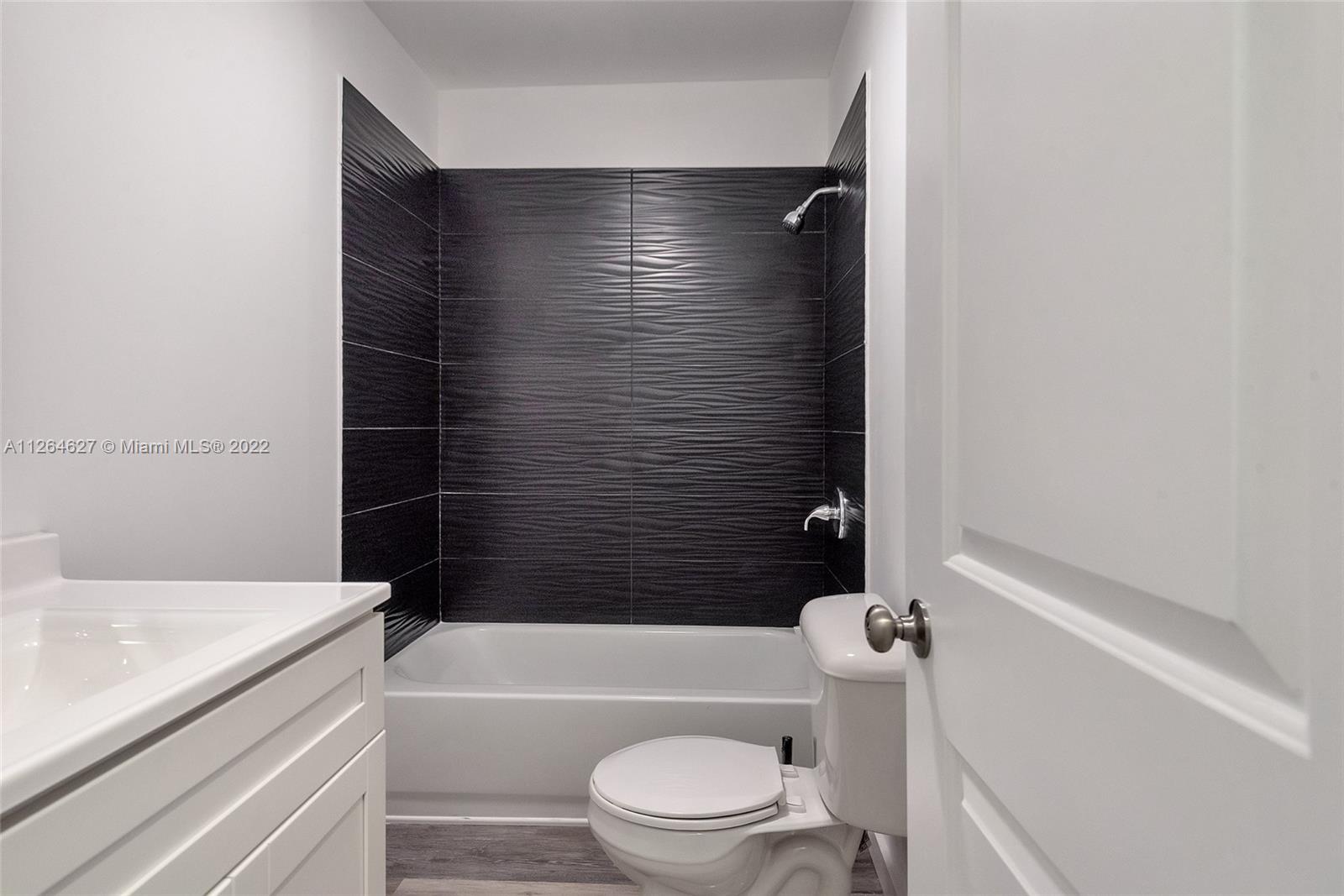 633 West 3rd Street Riviera Beach, FL 33404 - Photo 35 of 52 a bathroom with a bathtub and sink