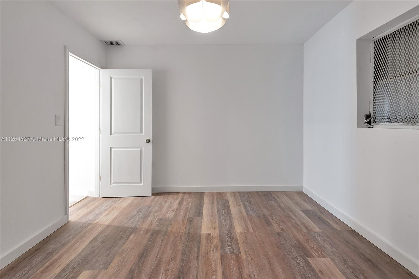 633 West 3rd Street Riviera Beach, FL 33404 - Photo 41 of 52 wooden floor in an empty room