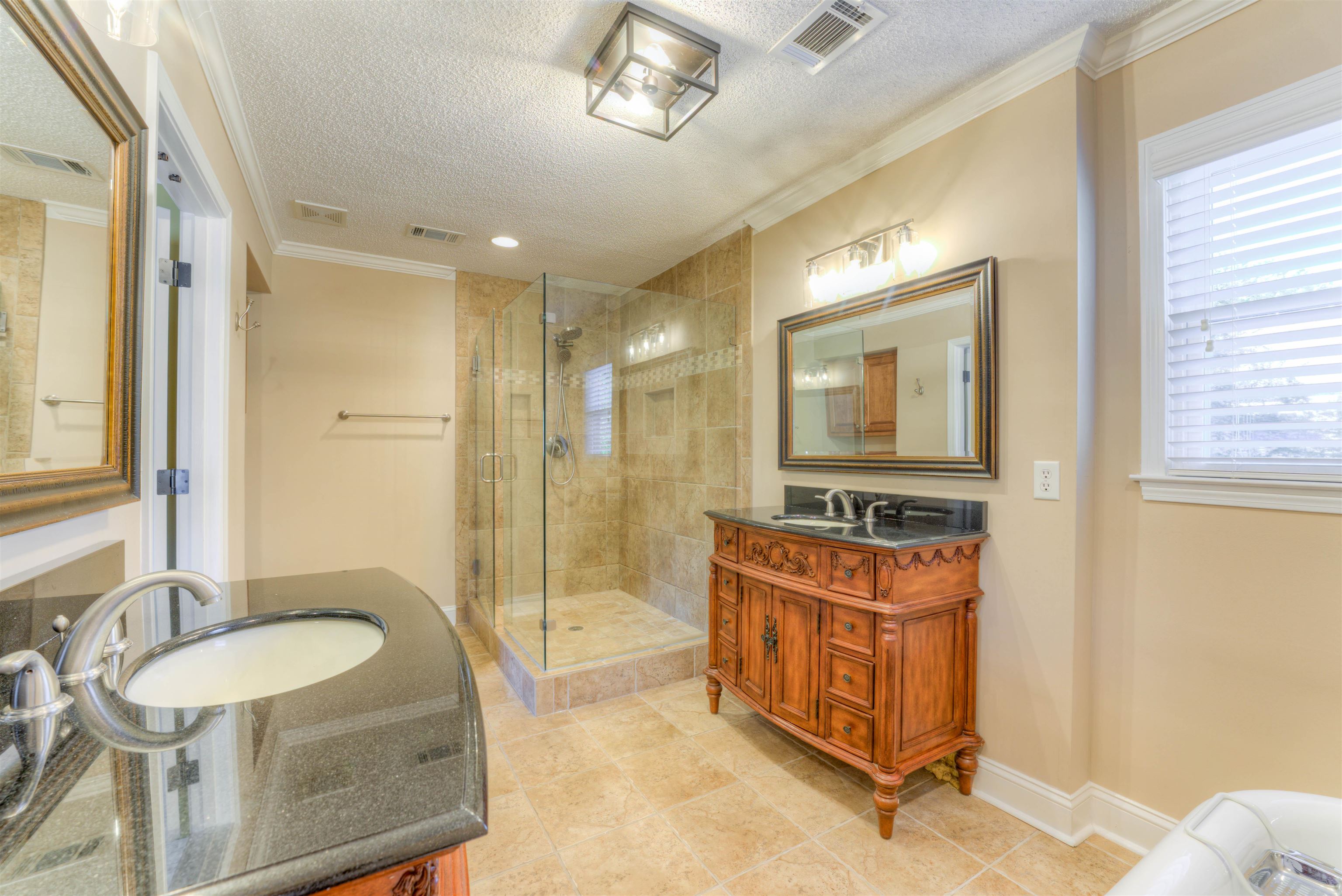 3385 Beaver Run Drive Collierville, TN 38017 - Photo 24 of 29 a bathroom with a sink a mirror a bathtub and shower