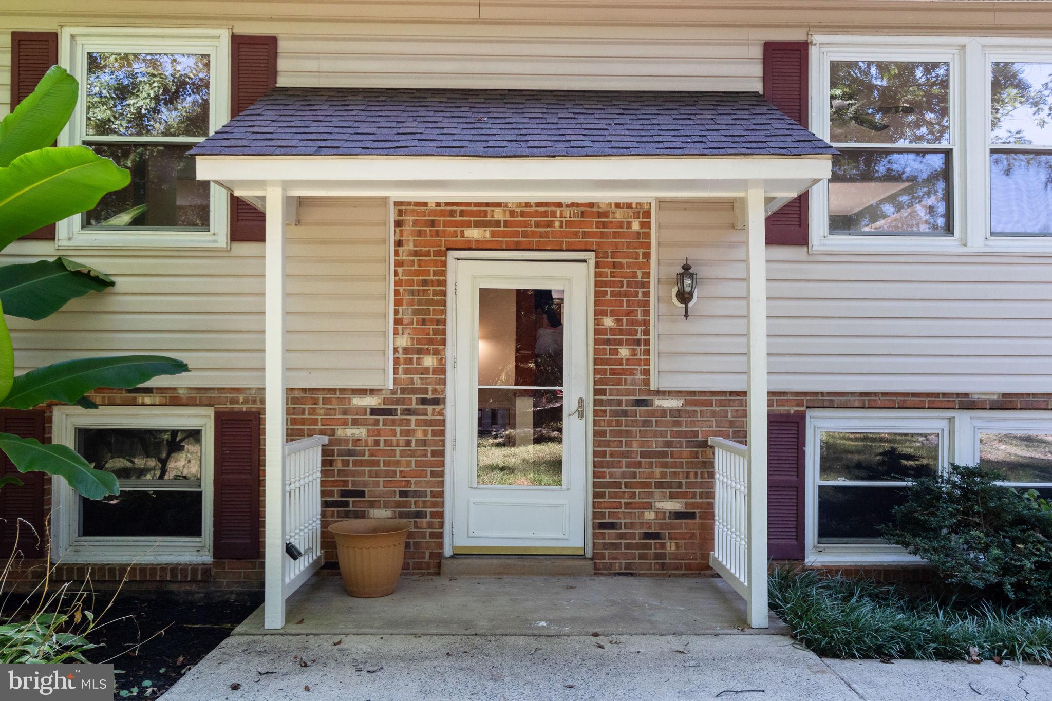 6035 Towles Mill Road Partlow, VA 22534 - Photo 12 of 66 a front view of a house with barbeque grill and potted plants
